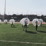 Bubble football match in the sun